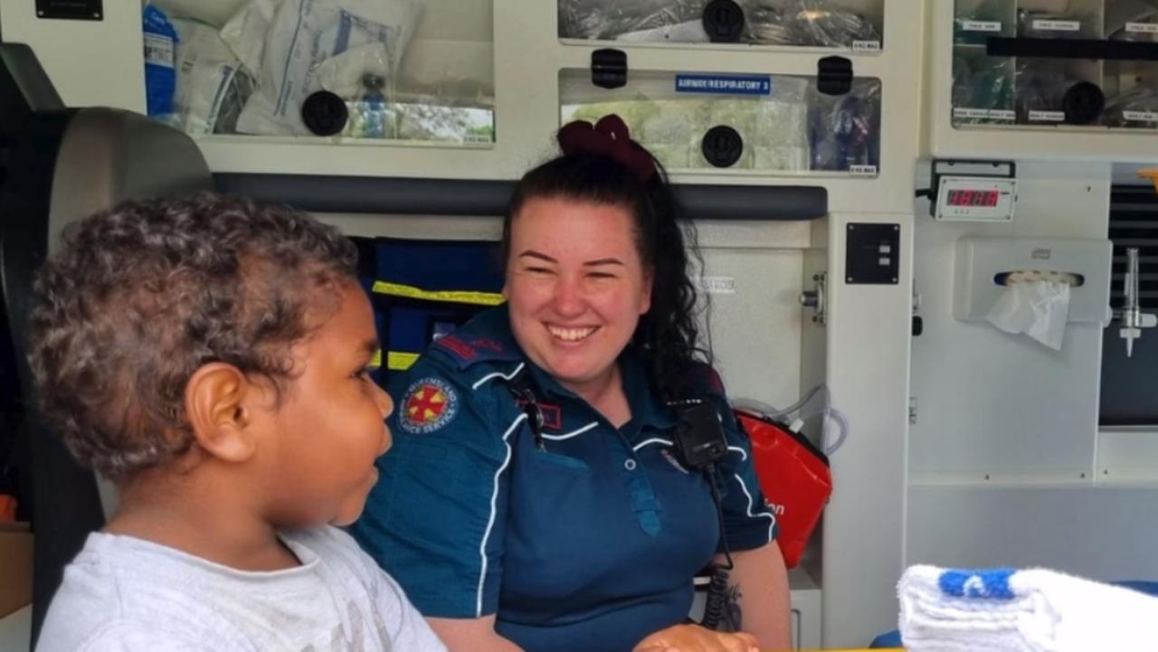 Saint got an exclusive tour with paramedic Jaynee inside an ambulance at Cooktown airport while eagerly awaiting his family's arrival from Wujal Wujal. Picture Queensland Ambulance