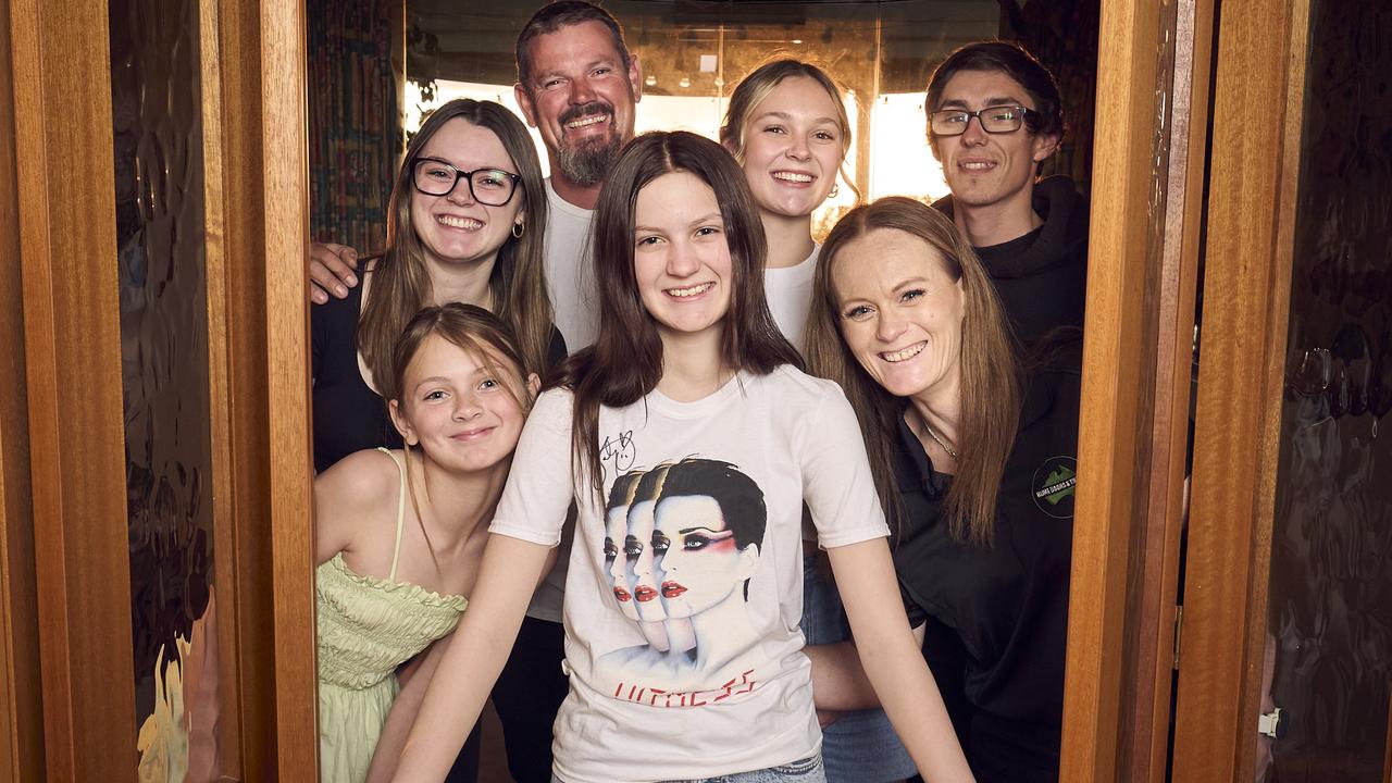 Grace Moores, 15, with her family, Chloe Moores, 12, Tiana Moores, Dale Moores, Aleysha Moores, Billy Moores and Marie Moores at home in Greenwith, six years after Katy Perry performed at her home when she wasn’t able to attend the concert due to brain cancer. Picture: Matt Loxton