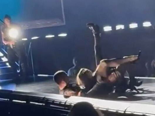 Madonna took a tumble on stage at her Seattle concert, falling backwards off her chair during a stunt.