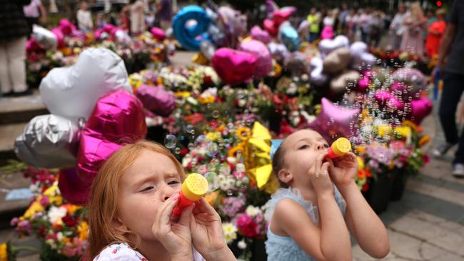 Children blow bubbles as people gather to mourn victims of the Southport knife attack that saw three young girls murdered by Axel Rudakubana.