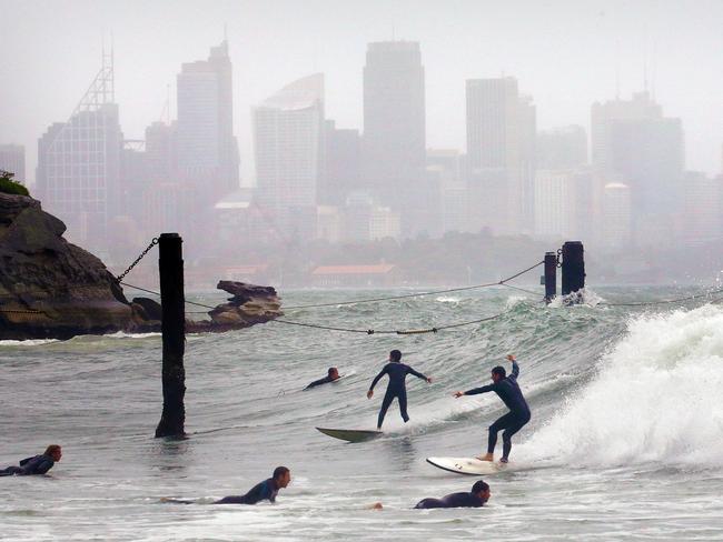 The storm didn’t stop these keen surfers at Nielsen Park, Vaucluse / Picture: Stephen Cooper