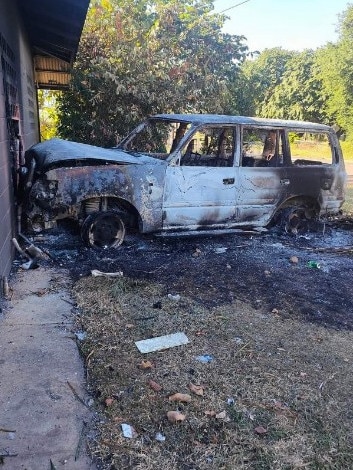 Police say the armed group who descended on the town damaged property before a vehicle was set alight