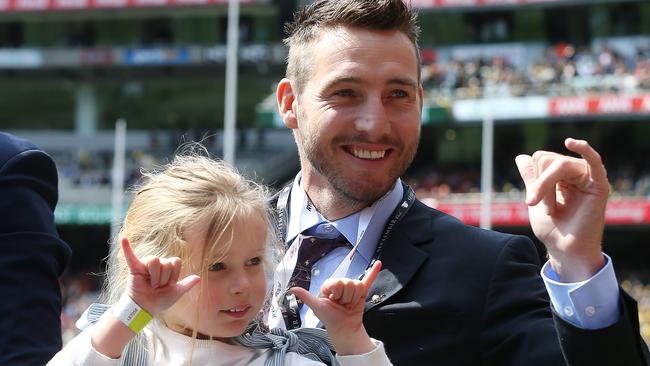 Dale Thomas during a lap of honour at the 2019 AFL Grand Final with his daughter Tilly. Picture: Michael Klein.