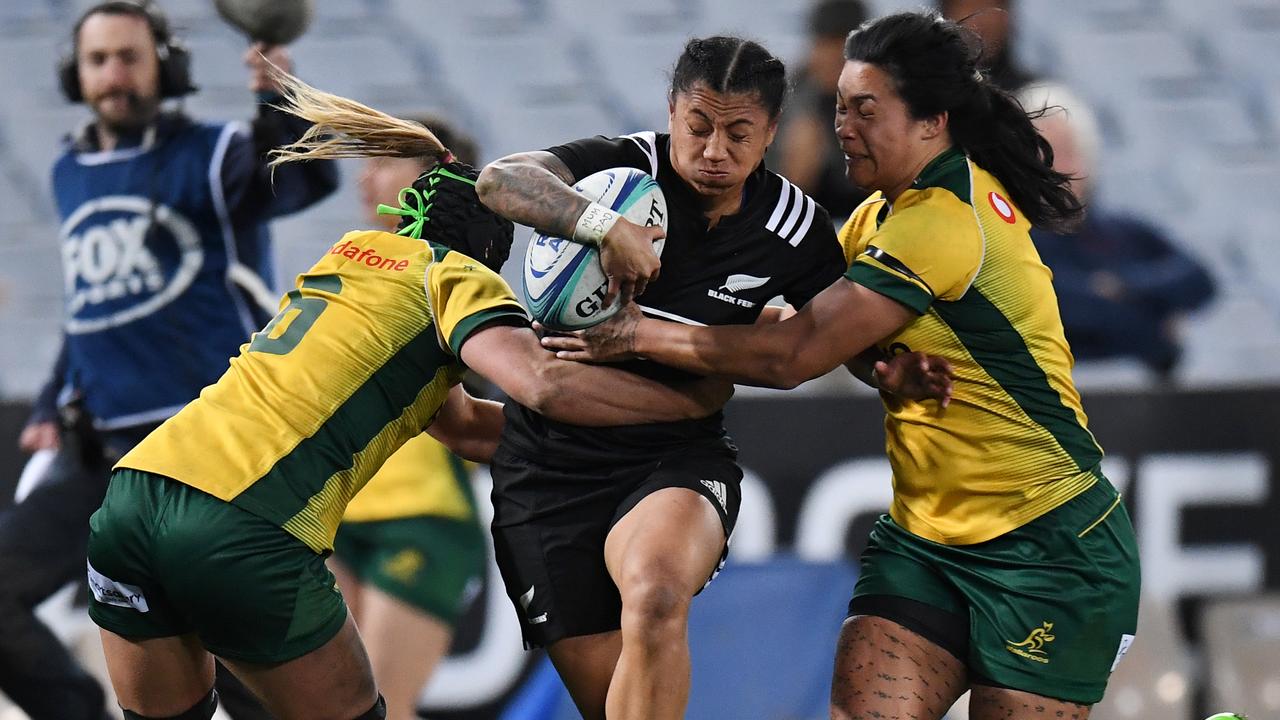 Les Elder of the Black Ferns is tackled by Emily Chancellor (left) and Liz Patu of the Wallaroos on Saturday. Picture: AAP