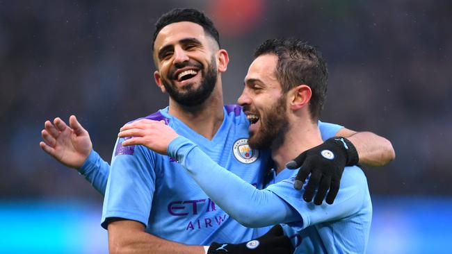 Bernardo Silva of Manchester City celebrates after scoring his team's second goal with Riyad Mahrez during the FA Cup Fourth Round match against Fulham.