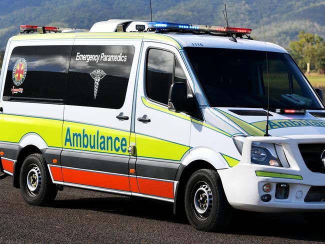 Emergency services attend a fatal car crash on the Bruce Highway, south of Townsville at Mount Surround. Garbage truck driver being looked over by paramedics.  Picture: Alix Sweeney