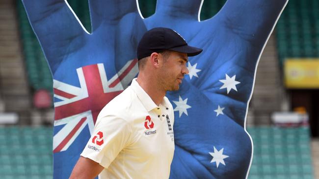 England's vice-captain James Anderson walks past a cutout of a hand indicating England's 4-0 series loss to Australia on the final day of the fifth Ashes cricket Test match at the SCG in Sydney on January 8, 2018. / AFP PHOTO / William WEST / — IMAGE RESTRICTED TO EDITORIAL USE — STRICTLY NO COMMERCIAL USE —