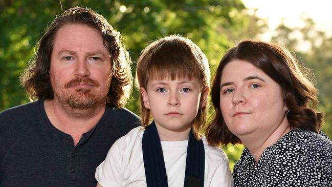 Oscar Girdler, 7, arm was broken at school by another kid after months of ongoing violence. Pictured with his parents Nathan and Jessica Girdler. Photo: Patrick Woods.