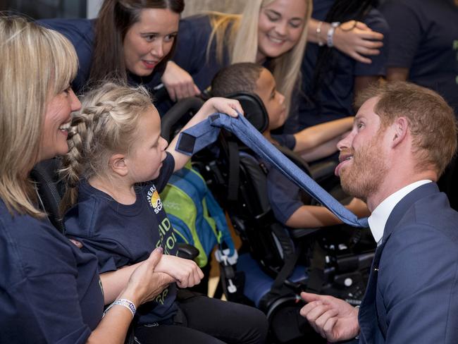 Prince Harry joined in the fun, pulling some faces to cheer kids up. Picture: MEGA