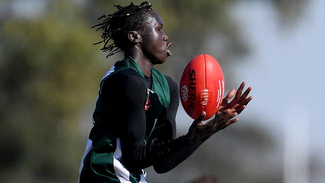 Bior Malual gathers the ball for Airport West. Picture: Andy Brownbill