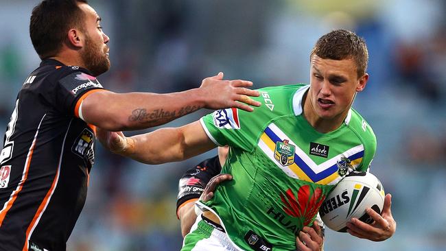 Jack Wighton fends off the tackle of Bodene Thompson.