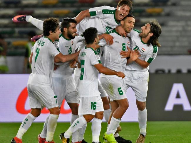 Iraq's defender Ali Adnan (2nd-R) celebrates after scoring a goal during the 2019 AFC Asian Cup group D football match between Iraq and Vietnam at Zayed Sports City stadium in Abu Dhabi on January 8, 2019. (Photo by Khaled DESOUKI / AFP)