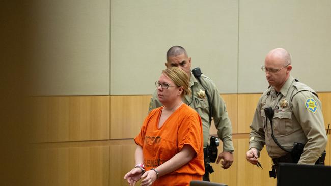 Lisa Cunningham is escorted back to a holding cell by Maricopa County Sherriff's officers on Sept. 12, 2018. Picture: Caitlin O'Hara/ News Corp Australia