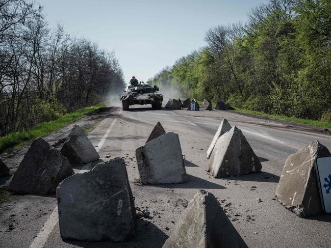 An Ukrainian tank drives through obstacles on a road near Slovyansk, eastern Ukraine. Picture: AFP