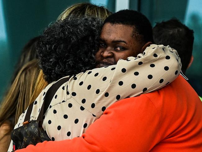 Family members and residents of the Champlain Towers South greet each other outside the Town of Surfside Community Center in Surfside.