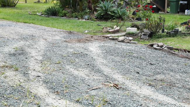 Car burnout tracks leading to bloody clothing at the attempted murder scene where a 27-year-old man allegedly drove over a woman in a backyard in Caboolture. Picture: Liam Kidston.