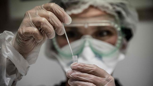 A medical assistant takes a sample from a patient at a Covid testing laboratory in Le Peage-de-Roussillon, some 30kms south of Lyon, south-eastern France on Tuesday. Picture: AFP