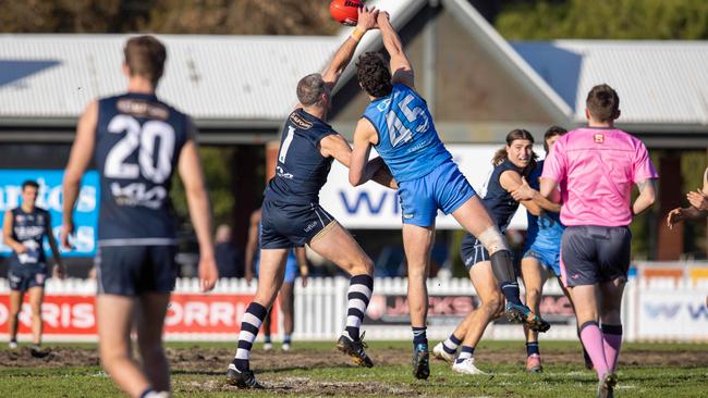 Sturt’s Amos Doyle (right) contests the ruck against South Adelaide’s Keegan Brooksby near the muddy cricket pitch area at Unley Oval on Sunday. Picture: Ben Clark