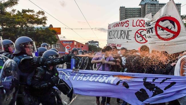 Police use pepper spray to disperse protesters. Picture: Jake Nowakowski