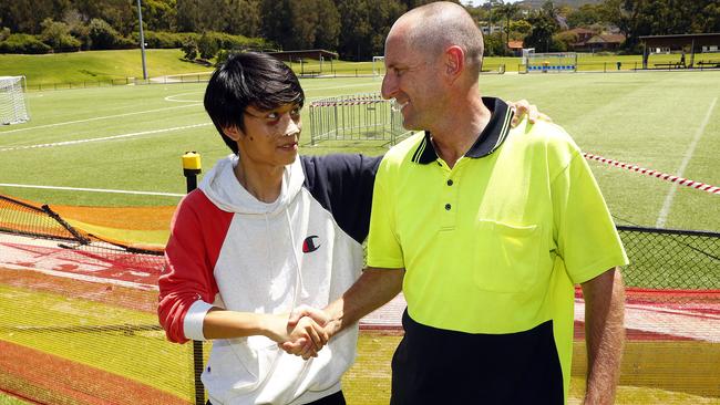 Horace Ho (left) thanks cricket player Greg Rollins who helped him after the crash. Picture: Sam Ruttyn