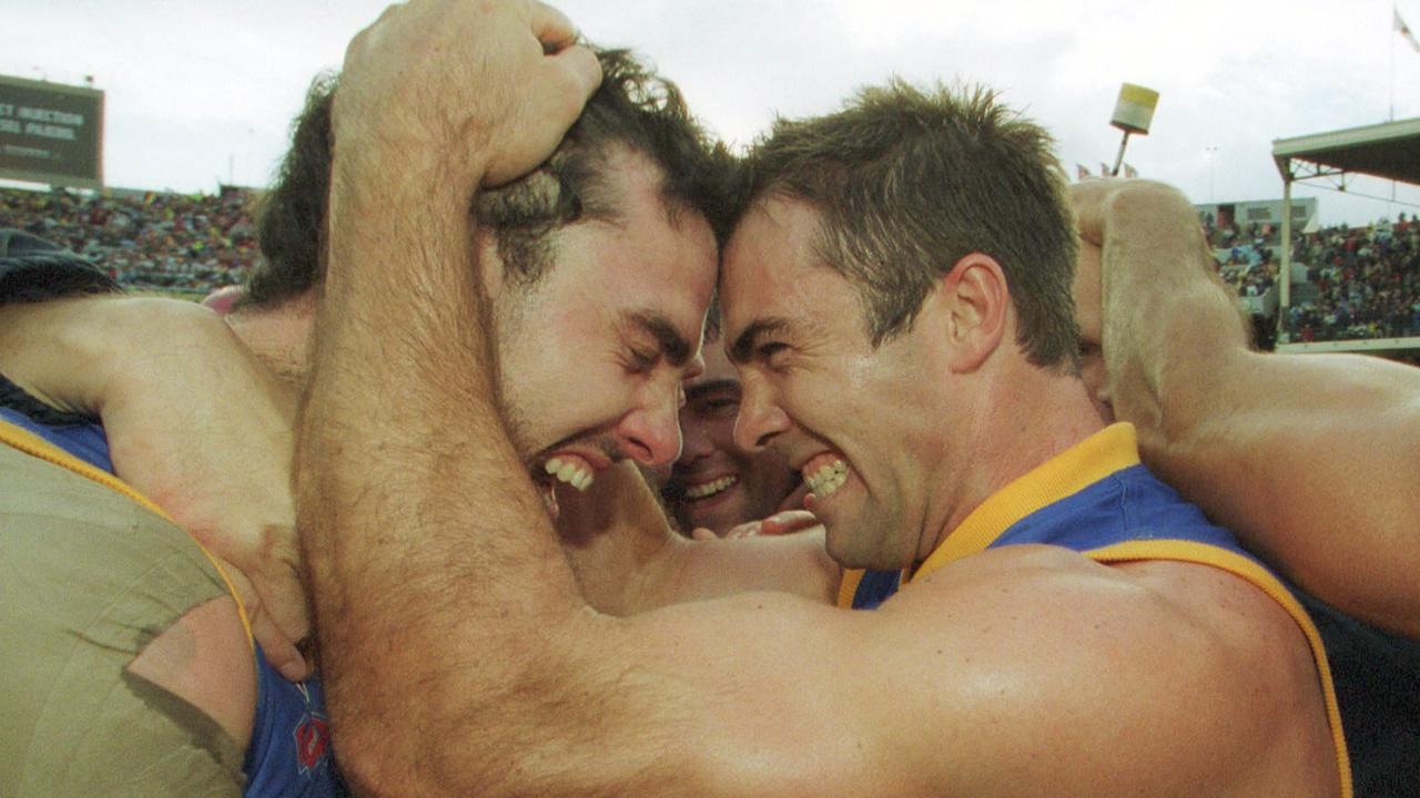 28/09/2002. Nigel Lappin and Chris Scott celebrate victory. 2002 Grand Final. Brisbane Lions v Collingwood. MCG.