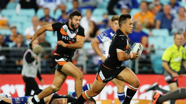 Tigers Luke Brooks sets up a try for Tigers James Tedesco during the Wests Tigers v Bulldogs rugby league game at ANZ Stadium, Sydney. Pic Brett Costello