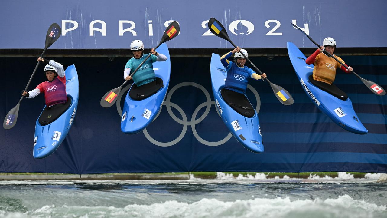 Australia's Noemie Fox (left) launches into her kayak cross race. Picture: AFP