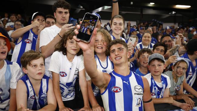 MELBOURNE, AUSTRALIA - MARCH 18: Harry Sheezel of the Kangaroos celebrates with fans after winning the round one AFL match between North Melbourne Kangaroos and West Coast Eagles at Marvel Stadium, on March 18, 2023, in Melbourne, Australia. (Photo by Daniel Pockett/Getty Images)