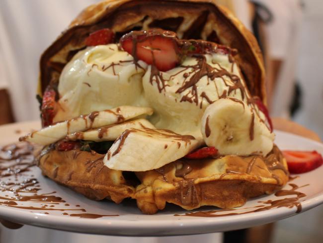 The waffles are stuffed with ice cream, strawberries and banana.