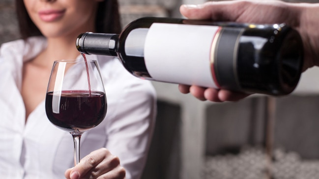 Woman being poured wine. (Pic: iStock)