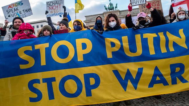 Demonstrators make their feelings clear at Berlin's Brandenburg Gate on Sunday. Picture: AFP