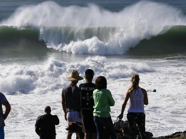 Locals look on as large waves break at Hastings Point in Northern NSW / Picture: Jason O'Brien