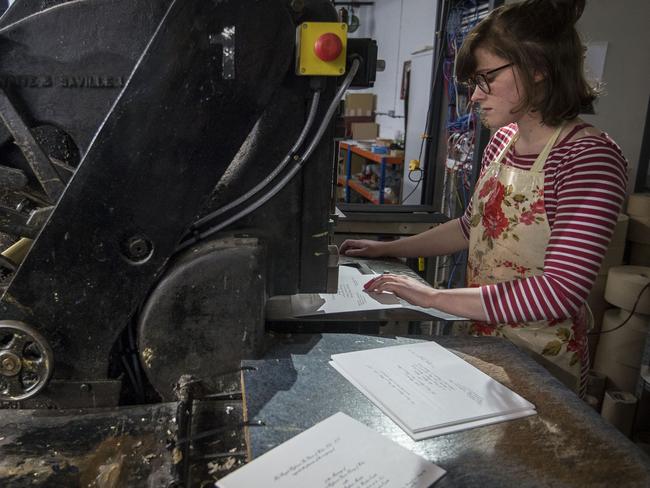 Lottie Small working the press of the royal wedding invites. Picture: Victoria Jones/Pool via AP.