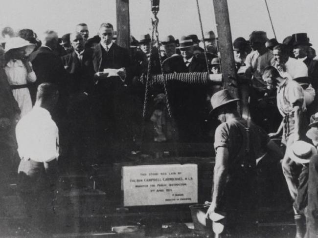 Laying the foundation stone for the building of Parramatta Public School and Parramatta High School on Macquarie St in Parramatta. The inscription on the stone reads: "This stone was laid by The Hon. Campbell Carmichael, M.L.A. Minister for Public Instruction 3rd April 1914, P. Board, Director of Education".