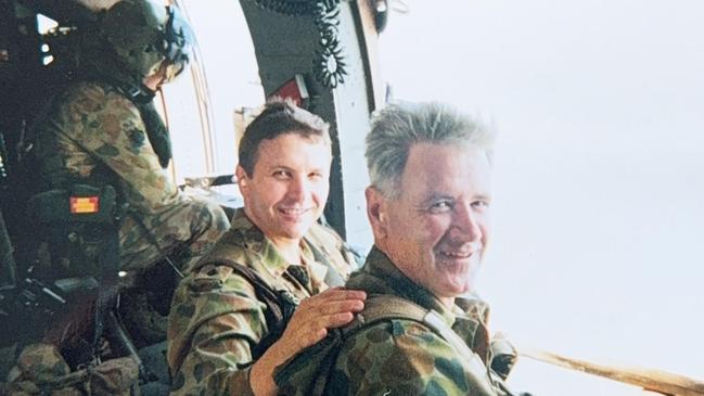 Bruce Armstrong aboard a Black Hawk helicopter with Warrant Officer Mick Caughey over East Timor in 2000.