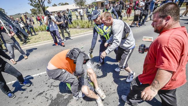 The anti-Islam protester is capsicum-sprayed by police. He yells more abuse after removing his shirt. Picture: Jason Edwards