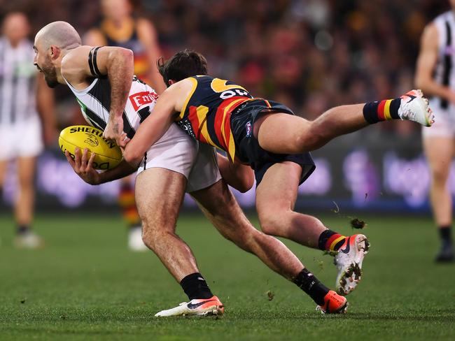 Collingwood’s Steele Sidebottom is tackled by Chayce Jones during the Crows/Magpies match at Adelaide Oval. Picture: Mark Brake/Getty