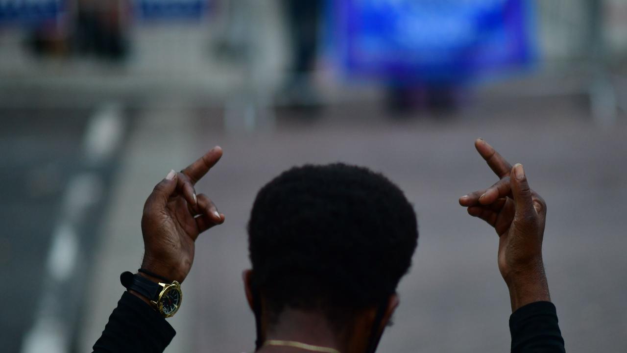 A Biden supporter gestures towards Trump supporters in Pennsylvania. Picture: Mark Makela/Getty Images/AFP