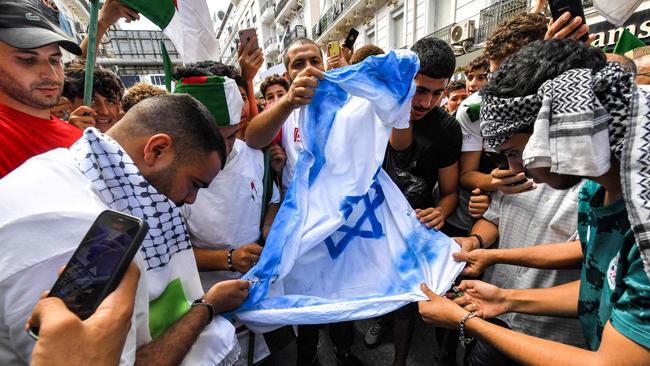 Protesters prepare to burn a make-shift Israeli flag during a demonstration in solidarity with Palestinians in Gaza.