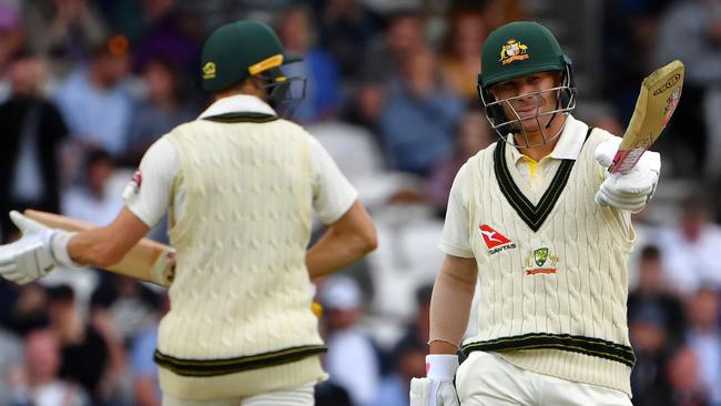 Australia’s David Warner points to the dressing sheds after reaching his 50. Picture: AFP