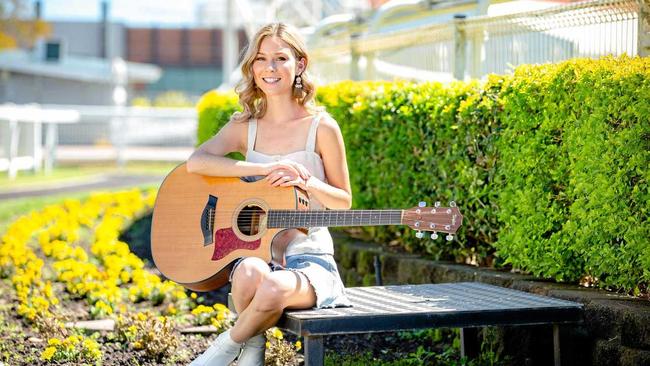 BACK IN THE SADDLE: Caitlyn Shadbolt poses for a photograph at Doomben Racecourse to promote Country Music Raceday. Picture: AAP - Richard Walker