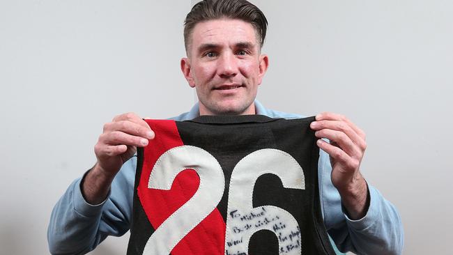 Mark Hardy with Mark ‘Bomber’ Thompson’s 1984 premiership jumper. Picture: Ian Currie