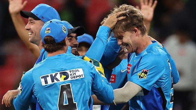 Adelaide Strikers teammates get around Henry Thornton after he proved the chief destroyer against Sydney Thunder. Picture: Cameron Spencer/Getty Images