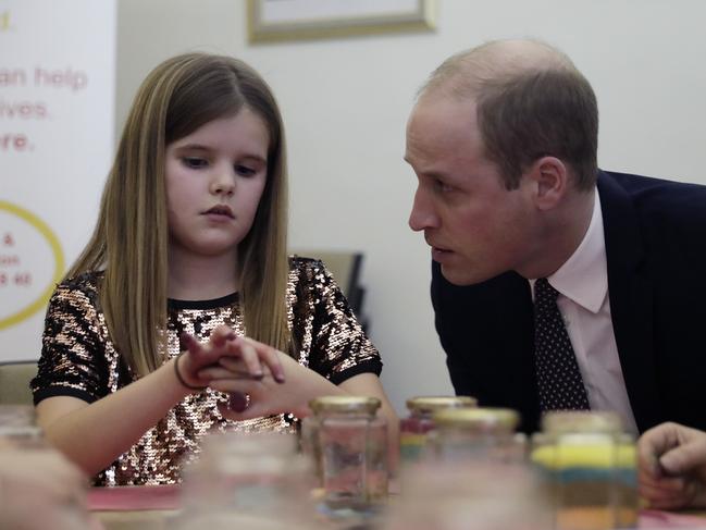 Britain's Prince William speaks with Aoife, 9, during his visit to a Child Bereavement UK Centre in Stratford in east London, Wednesday, Jan. 11, 2017. Prince William has been the royal patron of the Child Bereavement UK organisation since 2009. It supports families and educates professionals when a baby or child of any age dies or is dying, or when a child is facing bereavement. (AP Photo/Matt Dunham, Pool)