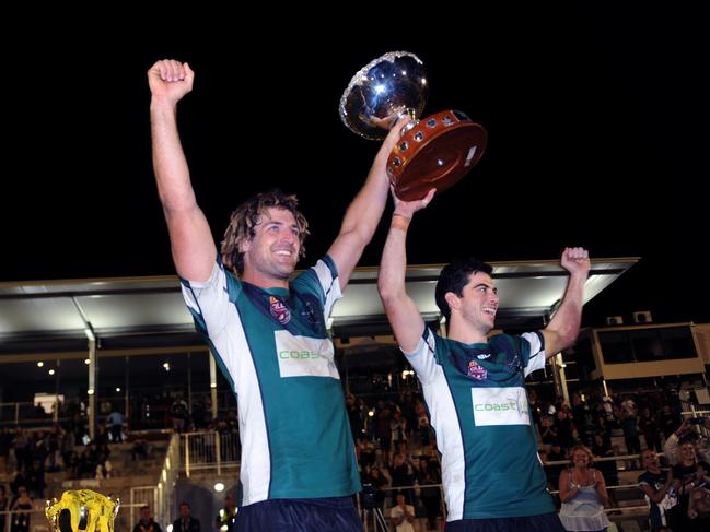 Maroochydore Swans stalwarts Murray Goldsworthy and Joshua Buckland lift the premiership trophy back in 2016. Photo: John McCutcheon