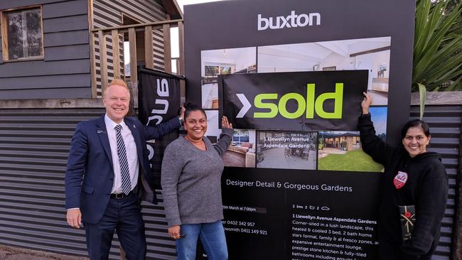 Buxton Dingley Village director Steven Turner with the happy buyers of 1 Llewellyn Ave.