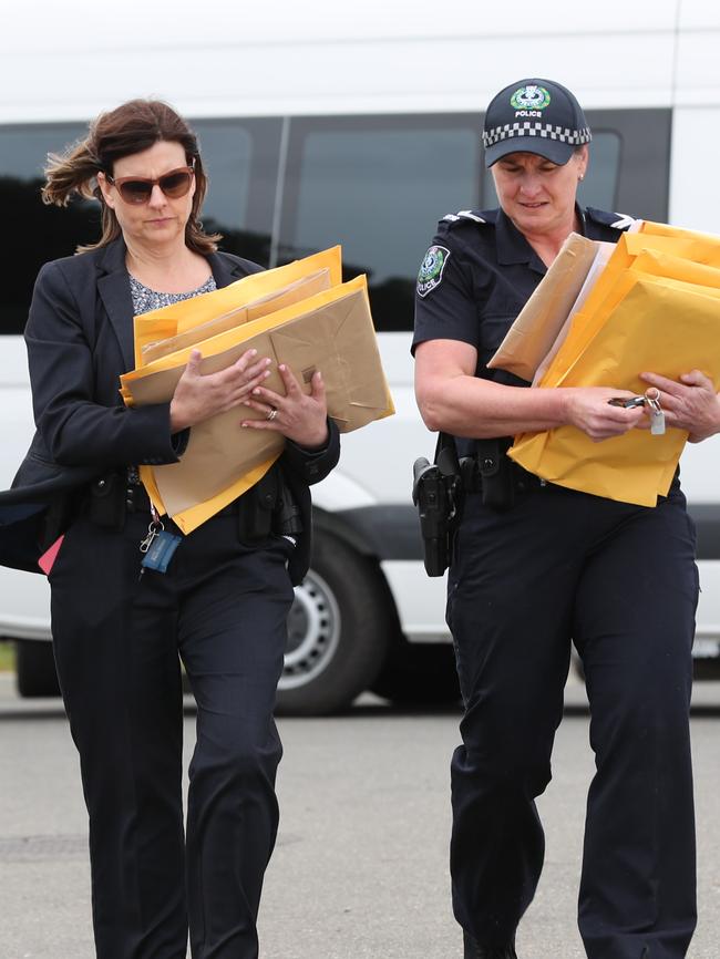 Police leave a southern suburbs home believed to be the home of an Integrity Care director with documents in September last year. Picture: Tait Schmaal