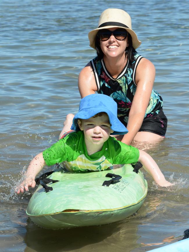 Teresa Little helping son Mason, 3, learn to paddle a board at Seacliff. Picture: Greg Higgs