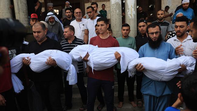 Relatives carry the bodies of children from the Abu Quta family who were killed in Israeli strikes on the Palestinian city of Rafah in the southern Gaza Strip. Picture: AFP