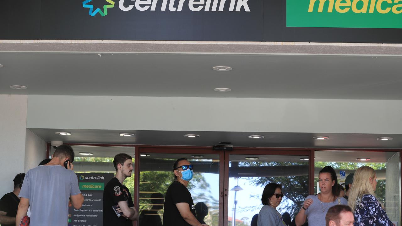 Lines of people wait at Southport Centrelink. Picture: Adam Head.